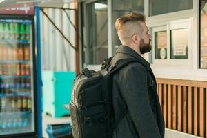 Portrait of man choosing fast food in food truck in the street. Meal, food industry and streetfood concept. photo