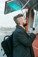 Portrait of man choosing fast food in food truck in the street. Meal, food industry and streetfood concept. photo