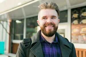 Portrait of happy man standing in front of food truck photo