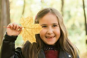 Autumn emotional portrait of laughing child walking in park or forest photo