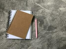 School books, office stationery, gray background photo