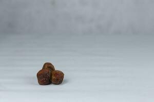 Pile of tasty dry dates isolated on white background photo