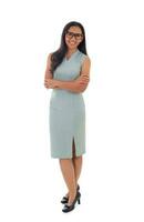 Full length image of attractive businesswoman wearing eyeglasses standing with arms crossed, isolated over white background photo