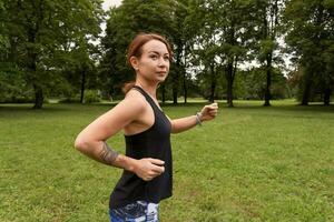 Sport woman doing running fitness in park photo