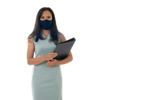 Flu epidemic, dust allergy, protection against virus concept- studio portrait of young asian business woman wearing a face mask, looking at camera, isolated on white background photo