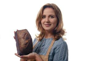 close up portrait of woman in apron showing a sourdough homemade bread, isolated on white background photo