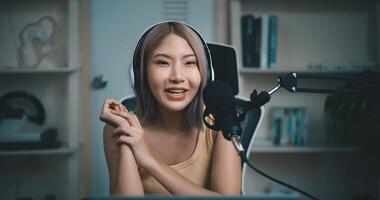 Cheerful Young podcaster use microphone during online podcast in studio photo