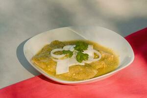 The Mexican enchiladas verdes, a staple food in Mexican cuisine, are served on a plate photo