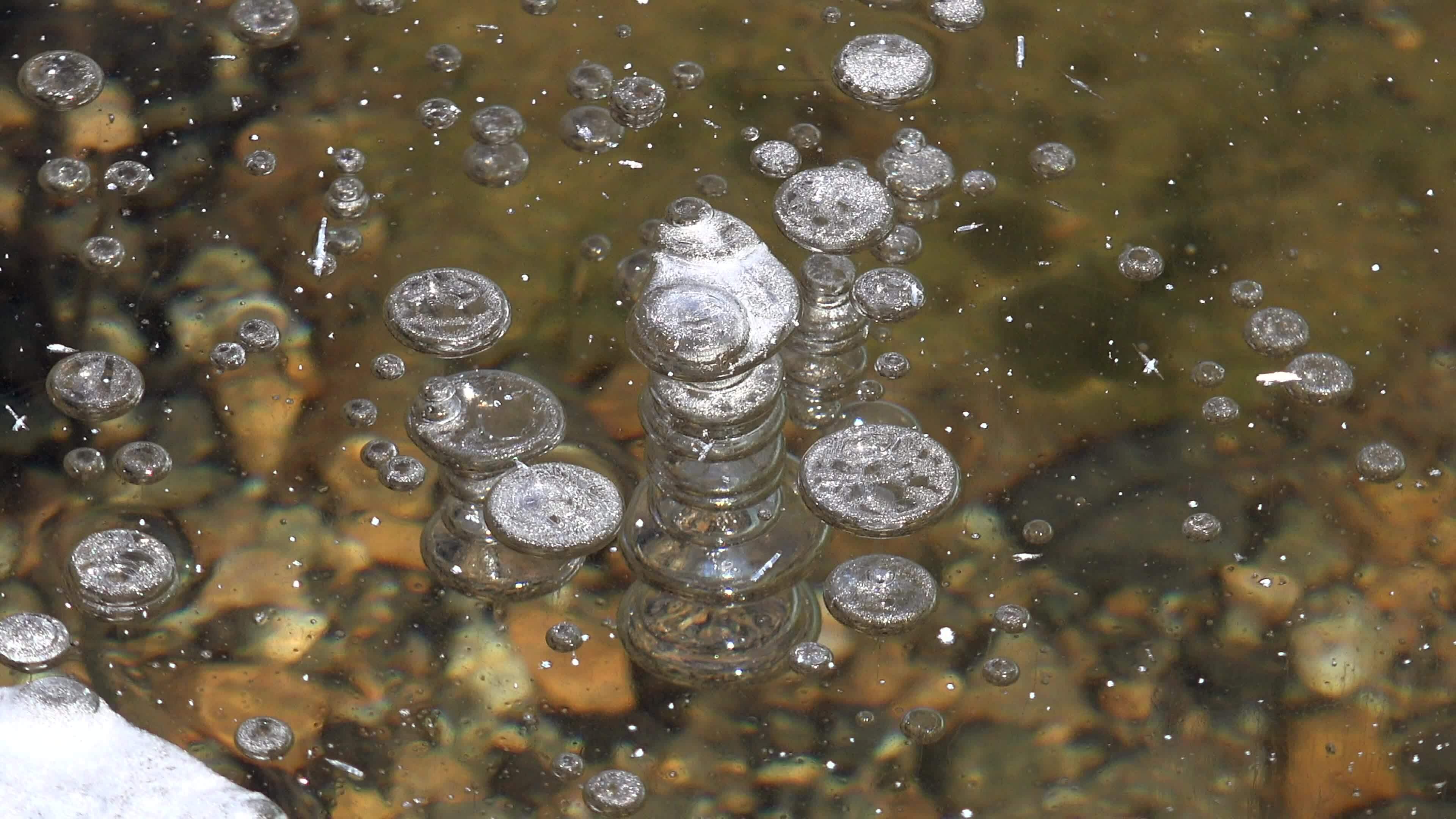 Frozen Methane Air Bubbles Trapped Under a Thick Floe Glassy Ice in