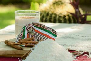 On the table in Mexico, cups of horchata and tableware await a joyful gathering. photo