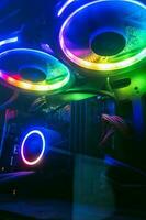 Vibrant neon lights showing the inside of a pc with graphics cards. photo