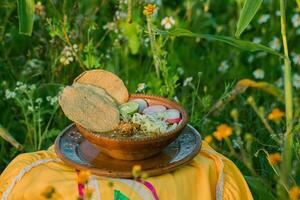 In Mexico, the vibrant red pozole, a traditional comfort food, is served in beautiful pottery bowls photo