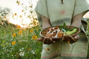 In Mexico, chilaquiles are a delicious and popular dish made with fried tortillas, sauce photo