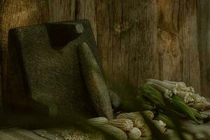 In the rustic kitchen, the wooden metate grinds corn, creating food and artistry photo