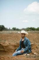 Cowboy under the vast sky, surrounded by cacti, working on a farm photo