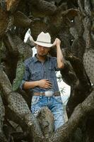 Smiling cowboy wearing a hat and sunglasses, enjoying outdoor adventures with a sense of fun photo