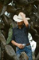 Smiling cowboy wearing a hat and sunglasses, enjoying outdoor adventures with a sense of fun photo