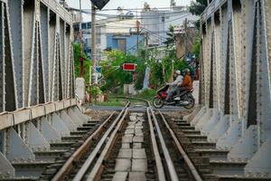 Ho Chi Minh, Viet Nam - 8 April 2023 Incredible view of train passing through a narrow street, the Hanoi Old Quarter. Stock photo