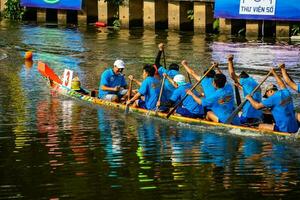 Ho Chi Minh, Viet Nam - 23 April 2023 Blurry motion of boat racing in the traditional Ngo boat racing festival of Khmer people photo