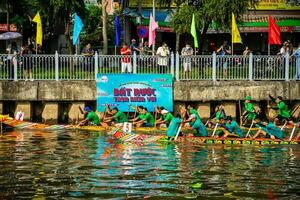 Ho Chi Minh, Viet Nam - 23 April 2023 Blurry motion of boat racing in the traditional Ngo boat racing festival of Khmer people photo