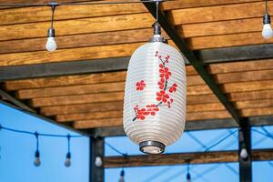 Small white paper lanterns with painting red flower photo