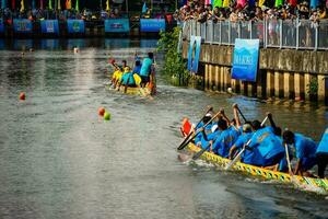 Ho Chi Minh, Viet Nam - 23 April 2023 Blurry motion of boat racing in the traditional Ngo boat racing festival of Khmer people photo