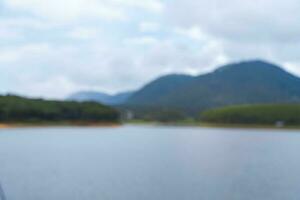 Nature blurred unfocused background. Mountains, forrest and lake. photo