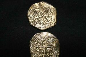 Gold And Silver Coins Laid Out on Display. photo