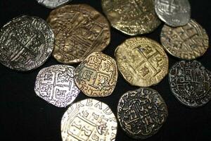 Gold And Silver Coins Laid Out on Display. photo