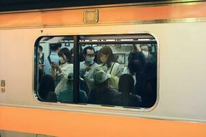 Tokyo Japan may 15 2023  A Glimpse into Tokyo's Commuting Culture Silent Conversations Amidst the Metro's Rush Hour photo