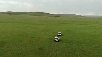 Two 4X4 Suv Cars Driving in The Treeless Vast Meadow video