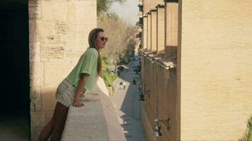 The girl looks from the balcony of the fortress at the panorama of the city video