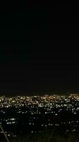 Night view of the city from the top of the hill photo