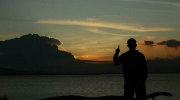 silhouette of man on the lake photo