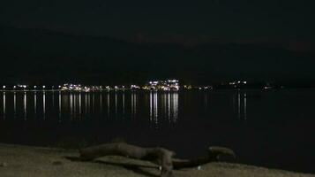 lake at night with view of city lights photo