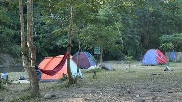 Beautiful morning landscape with camping tent on the river at sunrise photo