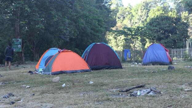 Beautiful morning landscape with camping tent on the river at sunrise photo