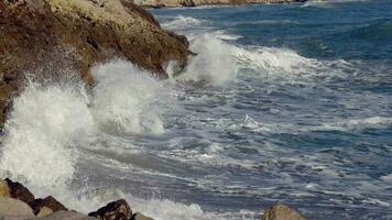 Big waves crash against the rocky shore video