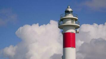 Lighthouse against the background of fast-moving white clouds video