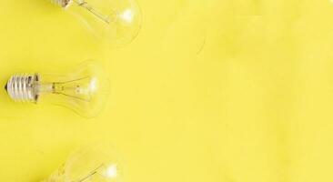 incandescent lamps on yellow background, copyspace. photo
