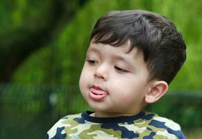 Cute Asian Pakistani Baby is Enjoying The Beautiful Sunny Day at Wardown Children and Public Park of Luton Town of England UK. Low Angle  Image Was Captured on April 03rd, 2023 photo