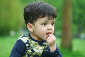 Cute Asian Pakistani Baby is Enjoying The Beautiful Sunny Day at Wardown Children and Public Park of Luton Town of England UK. Low Angle  Image Was Captured on April 03rd, 2023 photo