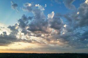 High Angle View of Luton City of England During Sunrise with Dramatical Clouds over Blue Sky. Image Was Captured with Drone's Camera on July 8th, 2023 photo