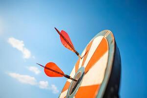 red darts arrows in the target center on blue sky background. Business target and success concept. photo
