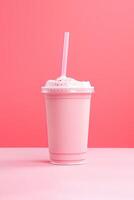 Strawberry milkshake in plastic takeaway cup isolated on pink background. photo