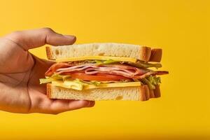 Hand holding tasty sandwich on a yellow background. ai generated photo