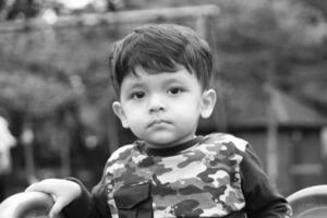 Cute Asian Pakistani Baby is Enjoying The Beautiful Sunny Day at Wardown Children and Public Park of Luton Town of England UK. Low Angle  Image Was Captured on April 03rd, 2023 photo