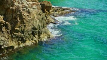 A majestic rocky cliff overlooking a serene body of water video