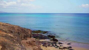 Rocky shore, beautiful sea and swimming diver. video