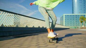 A girl rides a skateboard wagging video